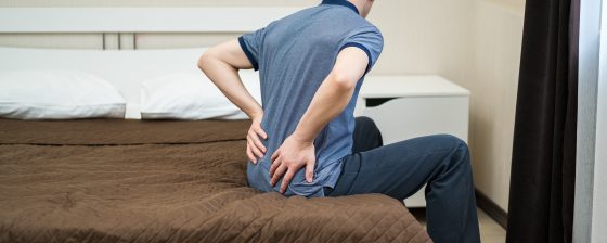 Back pain, kidney inflammation, man suffering from backache at home, health problems concept